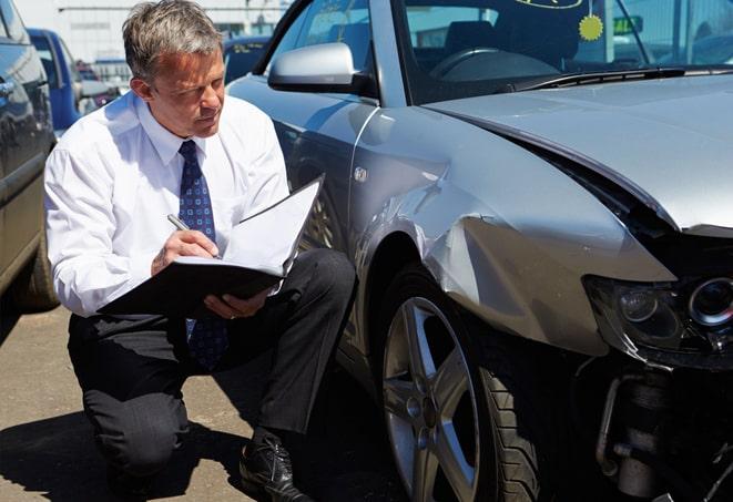 car keys and insurance policy on a wooden table